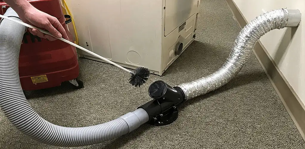 Dryer vent cleaning service removing lint from a dryer duct connection in Santa Ana, CA