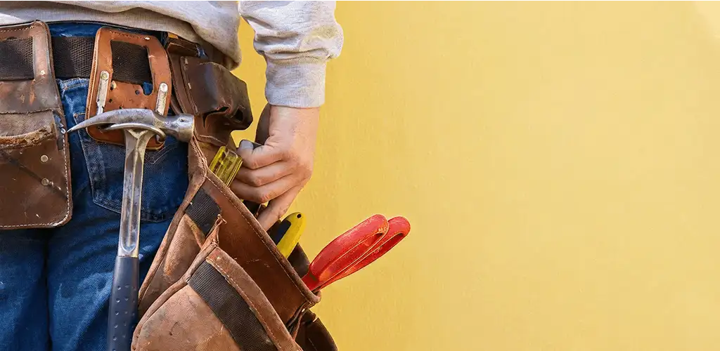 Handyman with tool belt ready for home repairs and maintenance in Santa Ana, CA