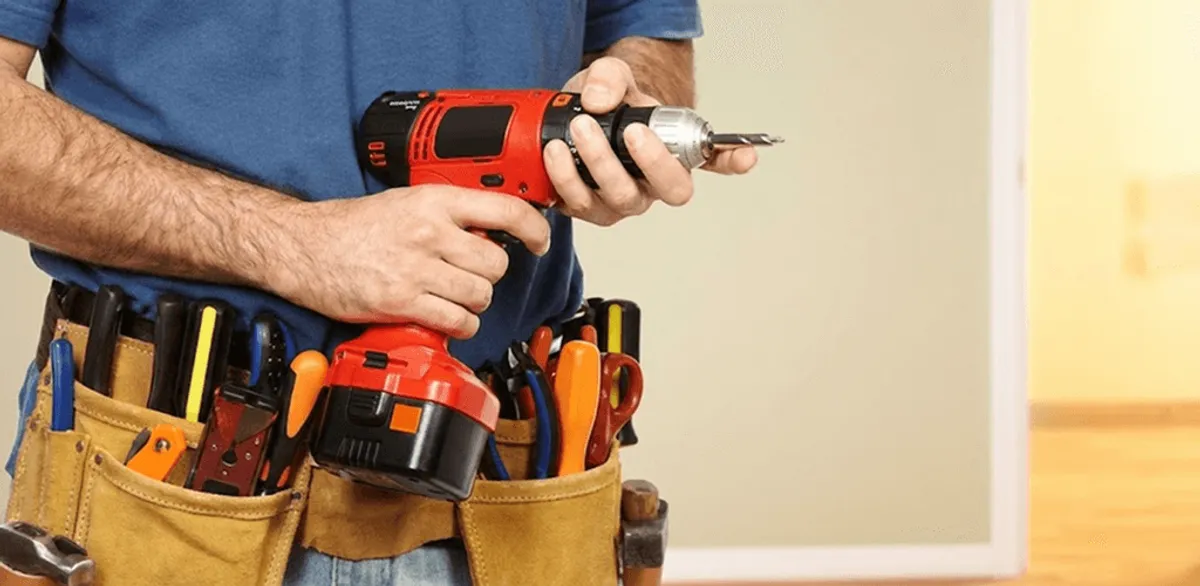 Handyman holding a power drill for home repairs and installations in Santa Ana, CA
