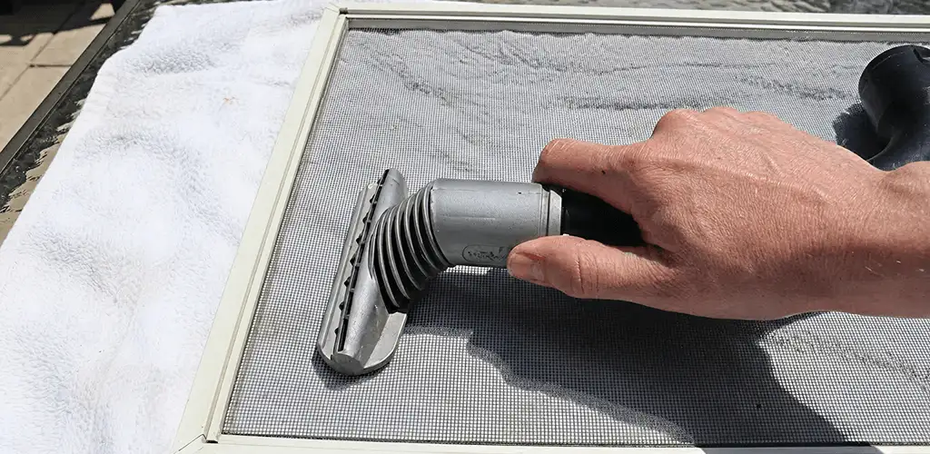 Window screen repair cleaning and fixing a damaged screen mesh in Santa Ana, CA